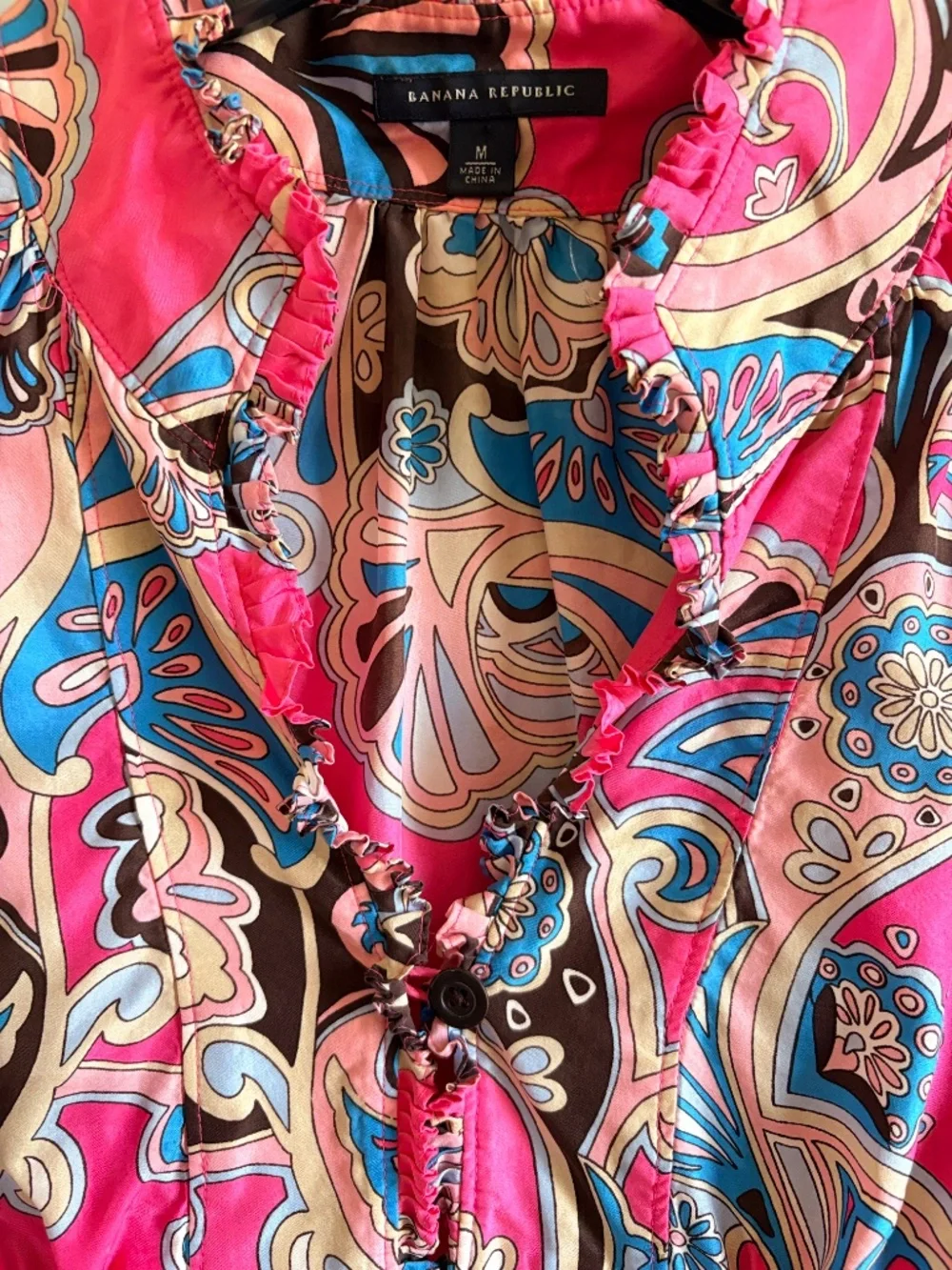 100% Silk ruffle-neck blouse.